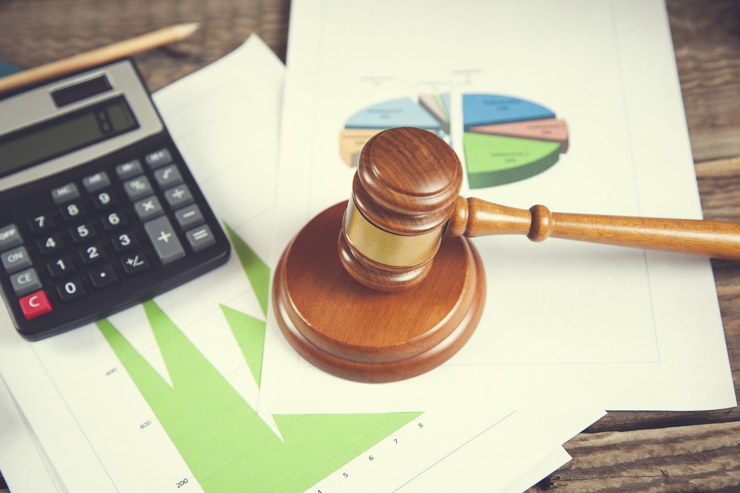 wooden gavel and calculator